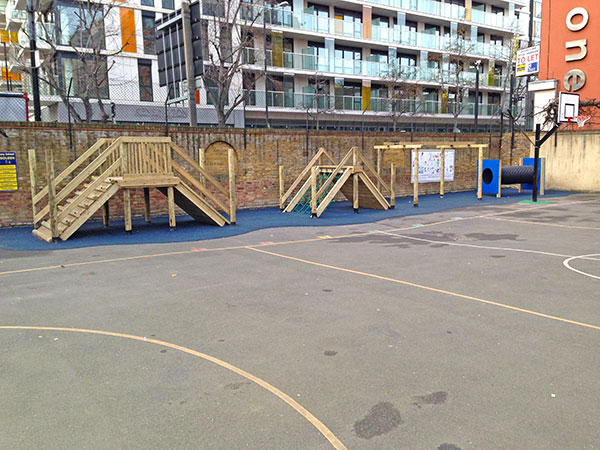 Adventure play areas with wooden platforms set at edge of playground
