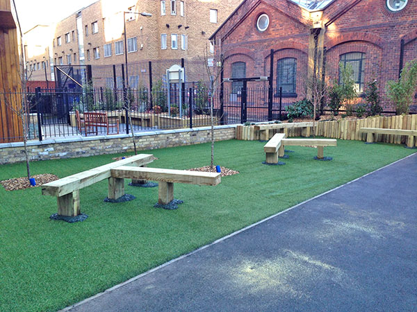 Seating with faux grass and safety surface playground upgrades